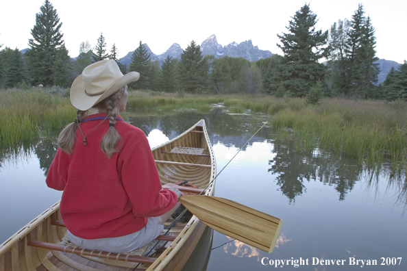 Woman in wooden canoe