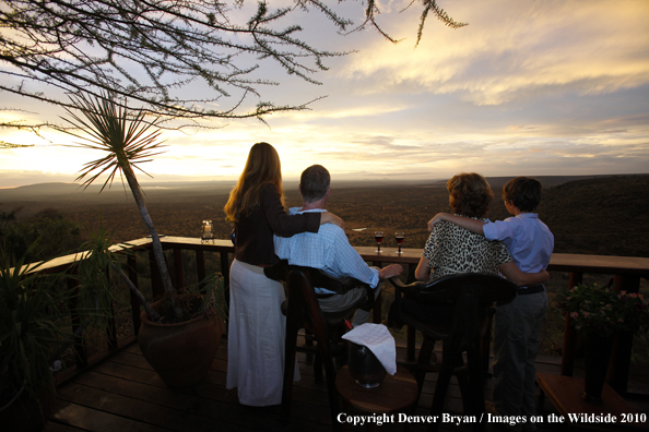 Family watching sunset on african safari