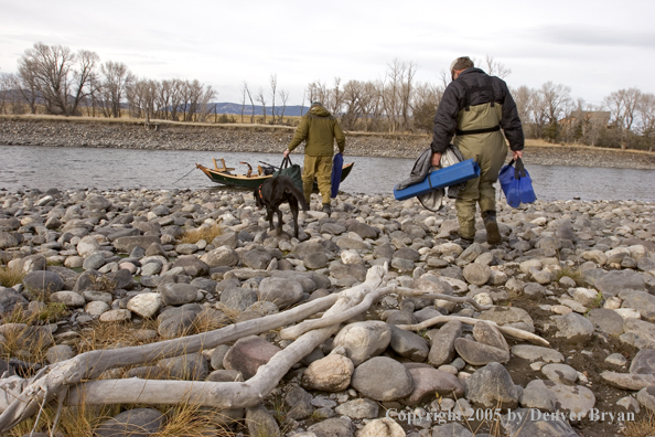 Flyfishermen rigging up driftboat and rods to fish. 