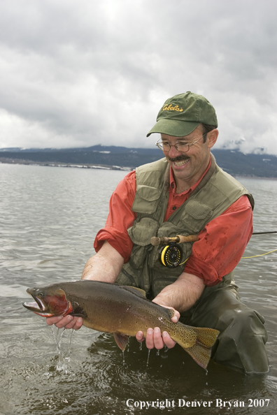 Flyfisherman with large cutthroat trout.