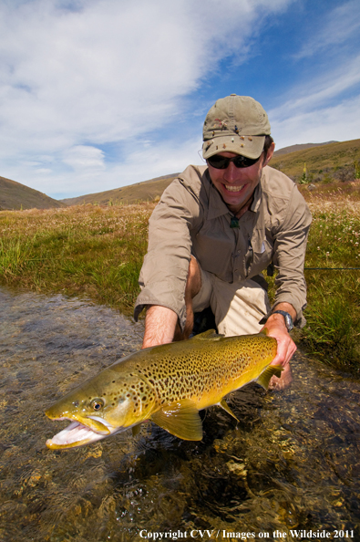 Flyfisherman with Brown trout. 