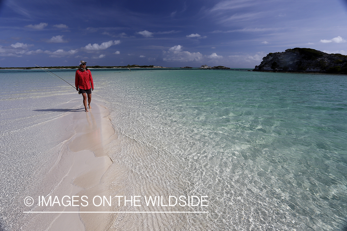 Saltwater flyfishing woman walking on flats.