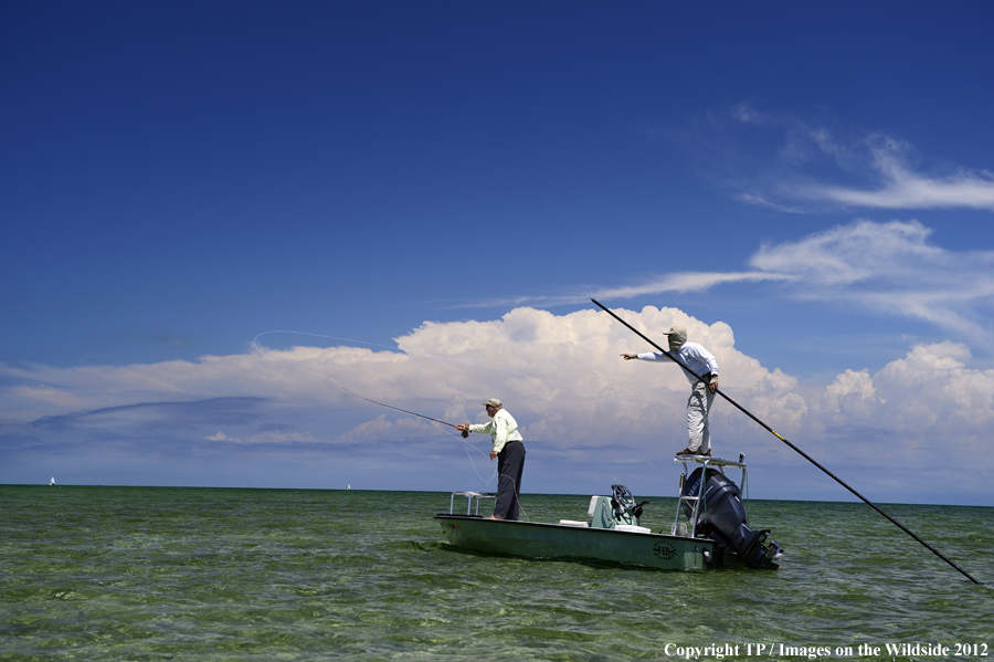 Flyfishermen on boat. 