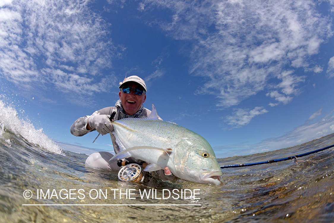 Flyfisherman with bluefin trevally.