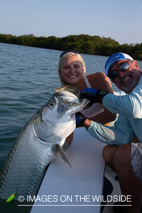 Saltwater fly fisherwoman and guide with tarpon.