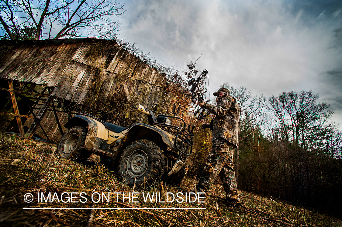 Bowhunter in field with ATV. 