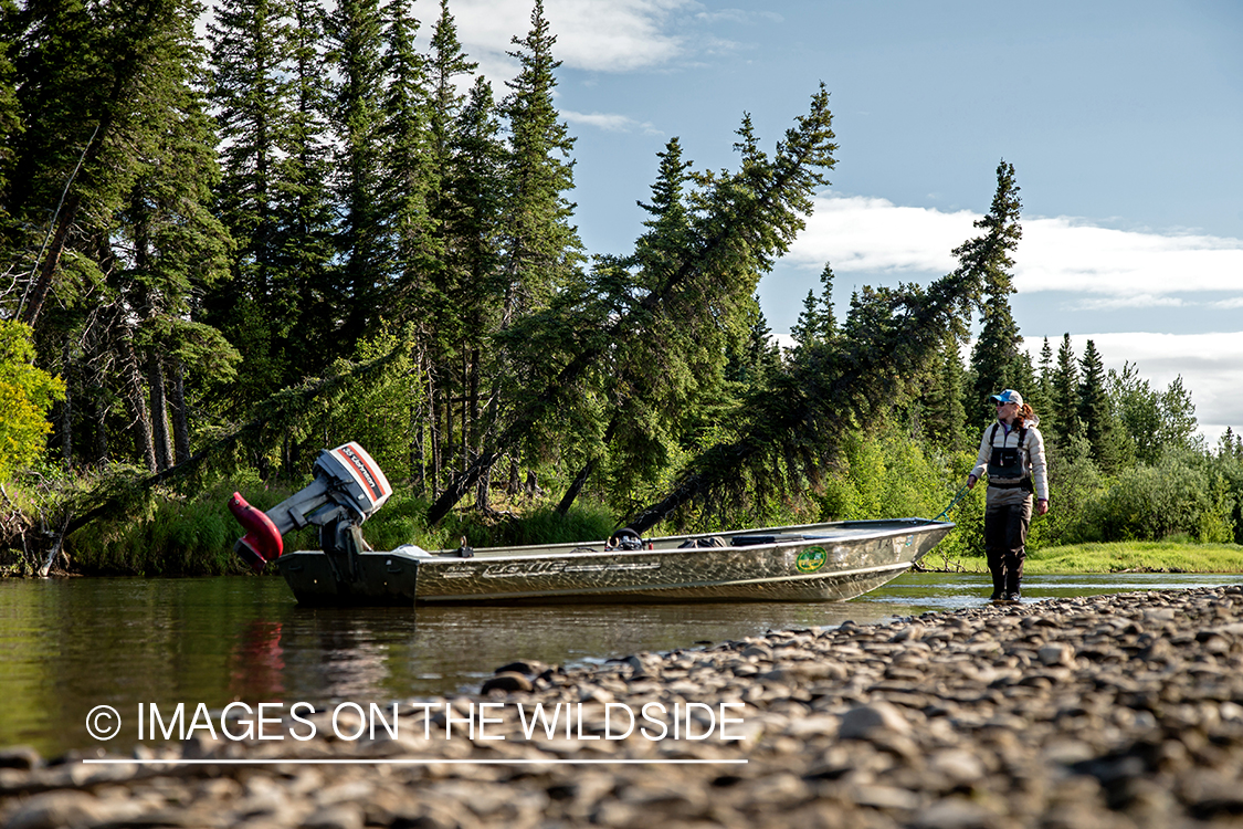 Flyfisherman pulling boat.