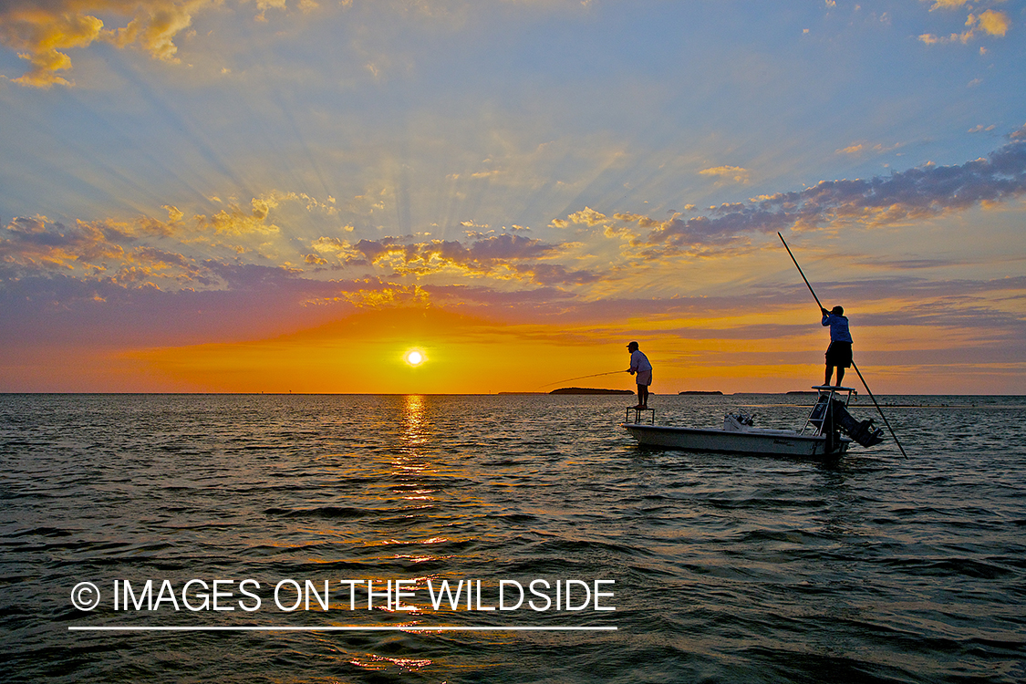 Flyfishermen fishing flats from boat.