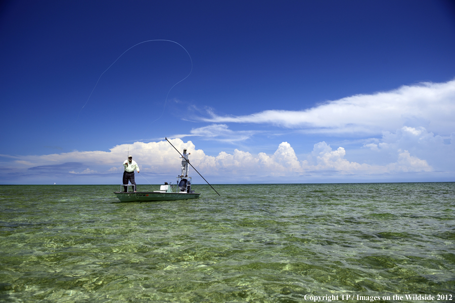 Flyfishermen on boat. 