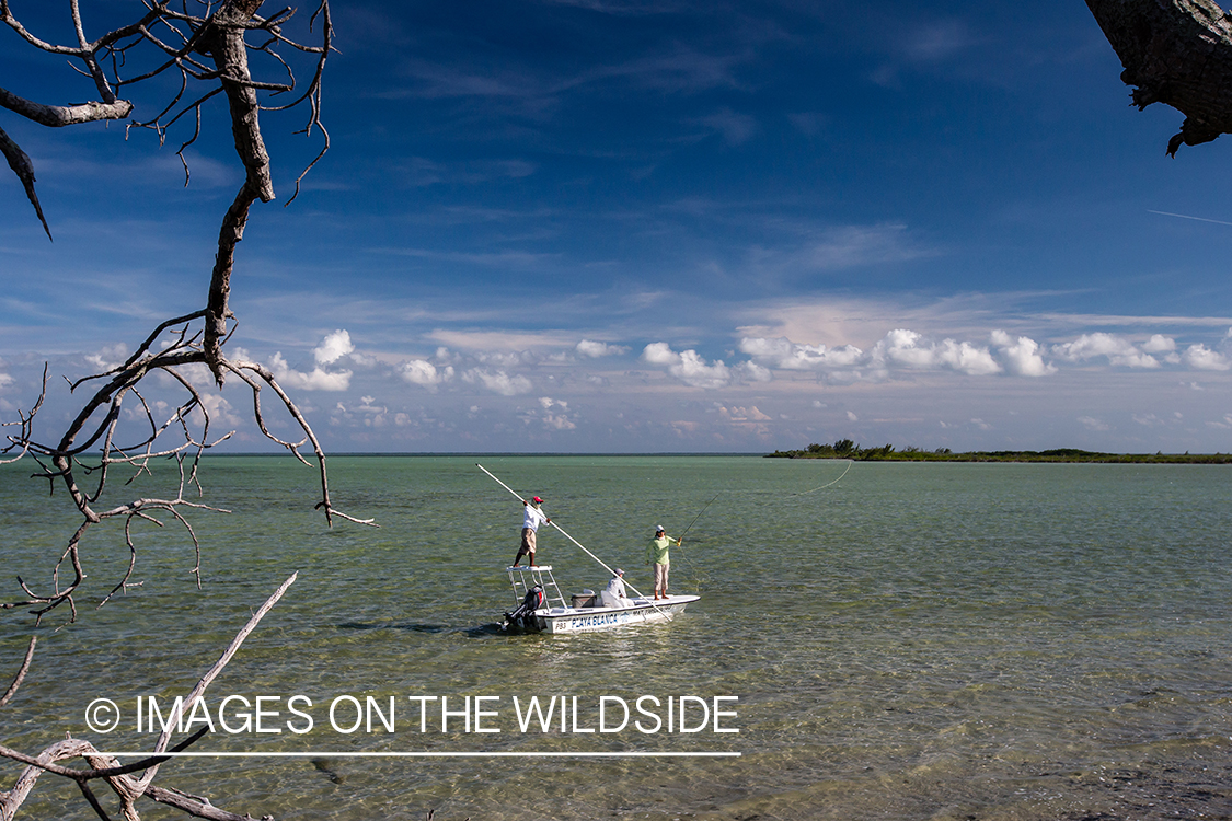 Flyfisherman with fishing guide on flats boat.