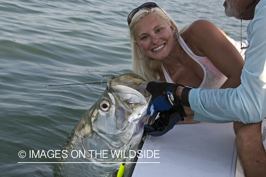 Saltwater fly fisherwoman and guide with tarpon.