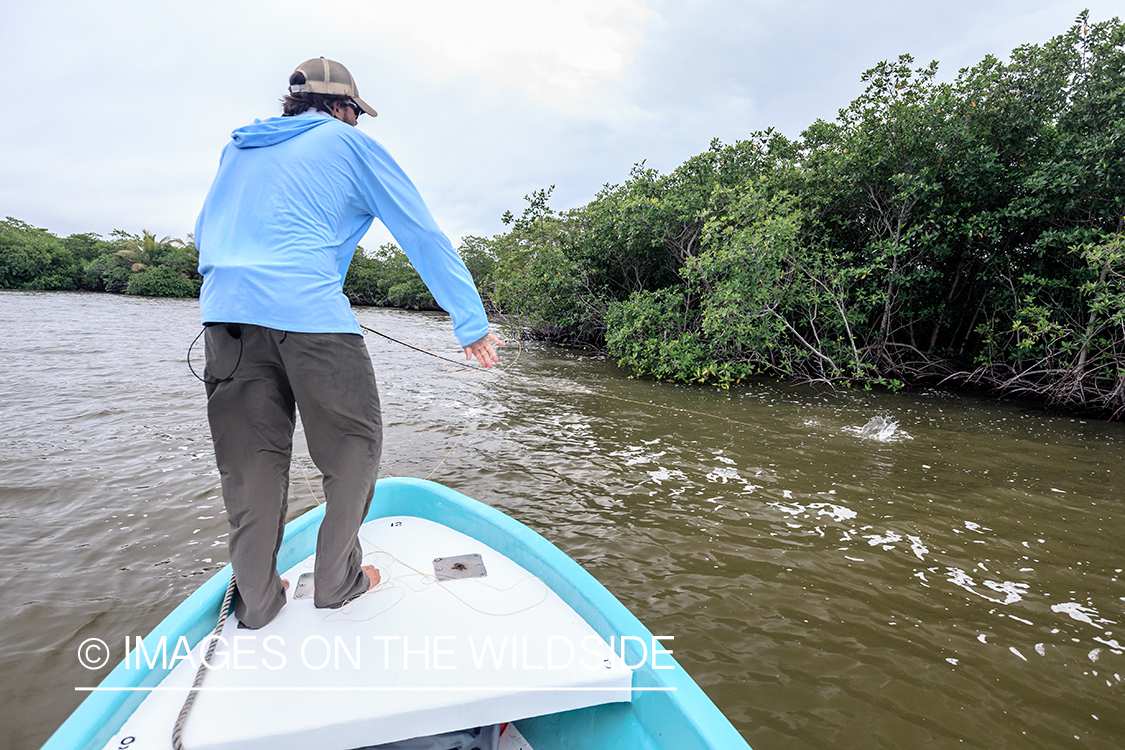 Flyfisherman fighting fish in Belize.