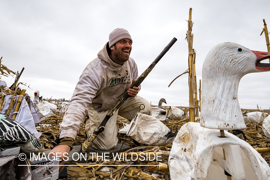 Hunters in field with decoys. 