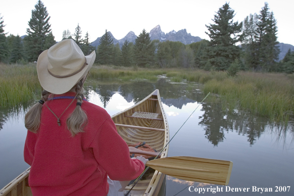 Woman in wooden canoe