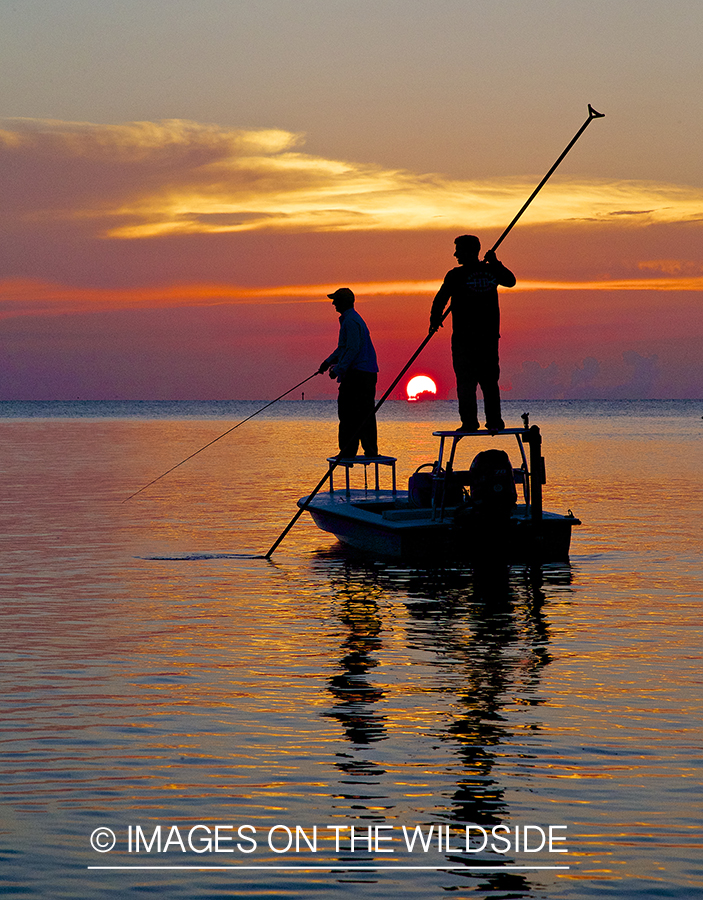 Flyfishermen fishing flats from boat.