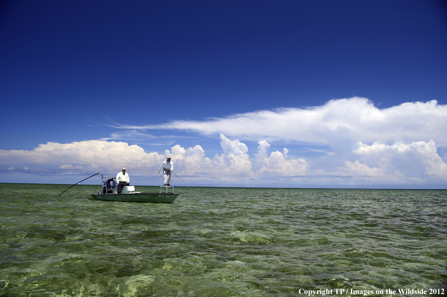 Flyfishermen on boat. 