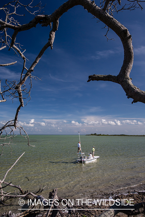 Flyfisherman with fishing guide on flats boat.