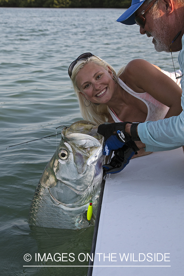 Saltwater fly fisherwoman and guide with tarpon.