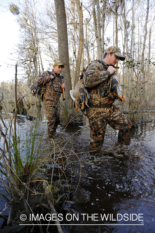 Waterfowl hunters with bagged waterfowl in southern wetlands. 