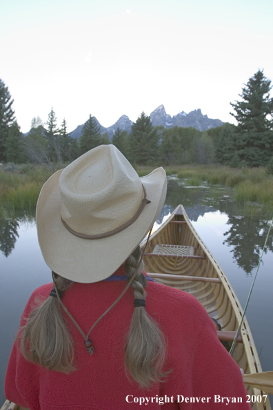 Woman in wooden canoe