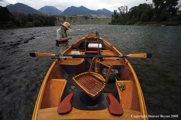 Flyfisherman with drift boat in forefront.