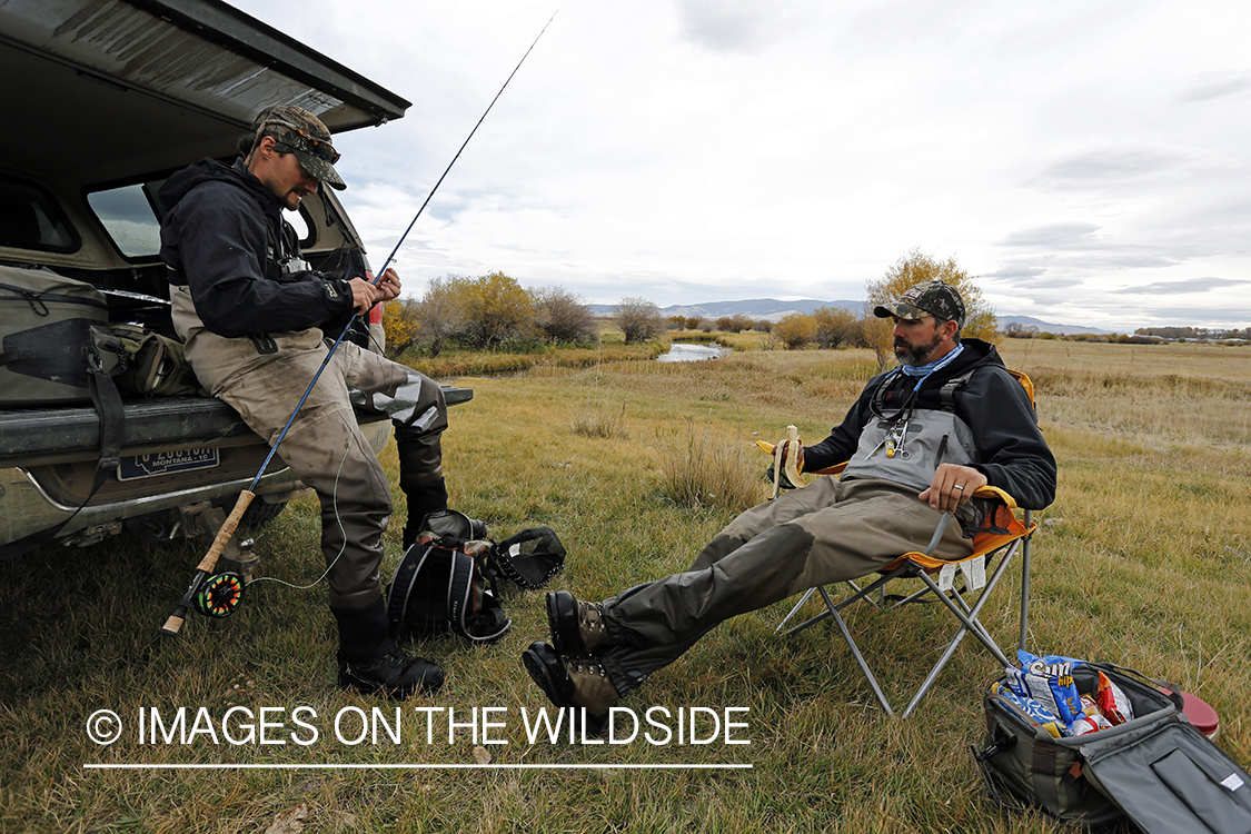 Flyfishermen in field.