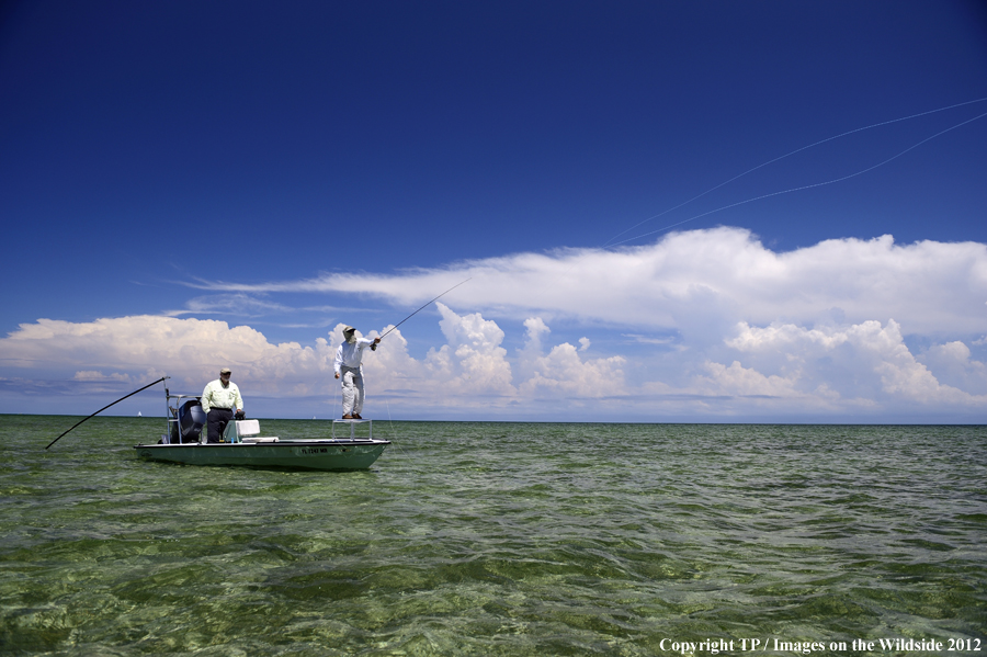 Flyfishermen on boat. 