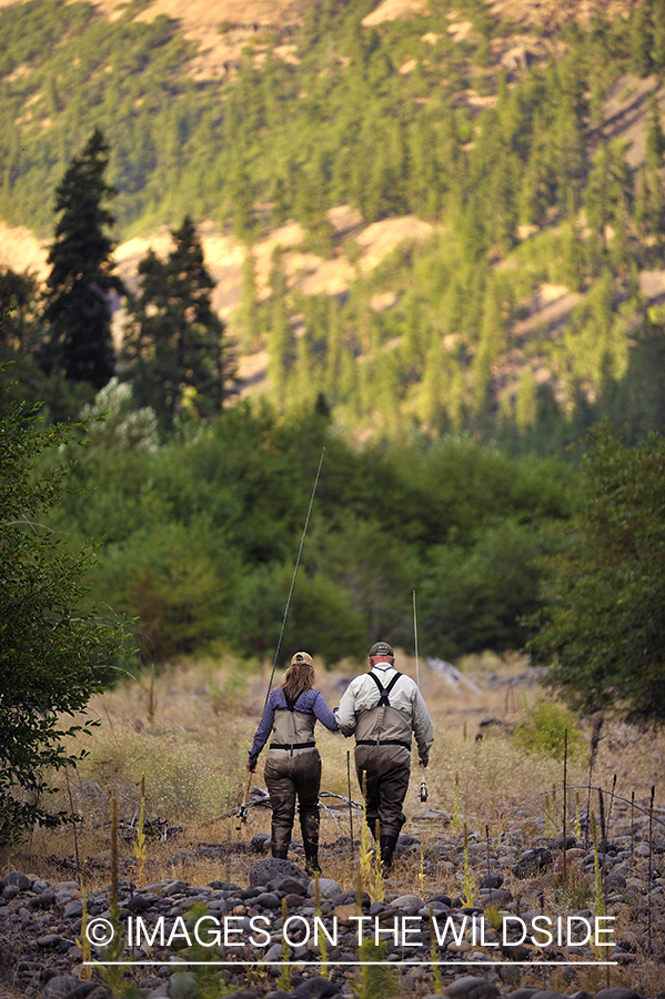 Flyfishers walking back from river. 