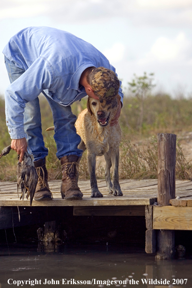 Yellow Labrador Retriever and owner