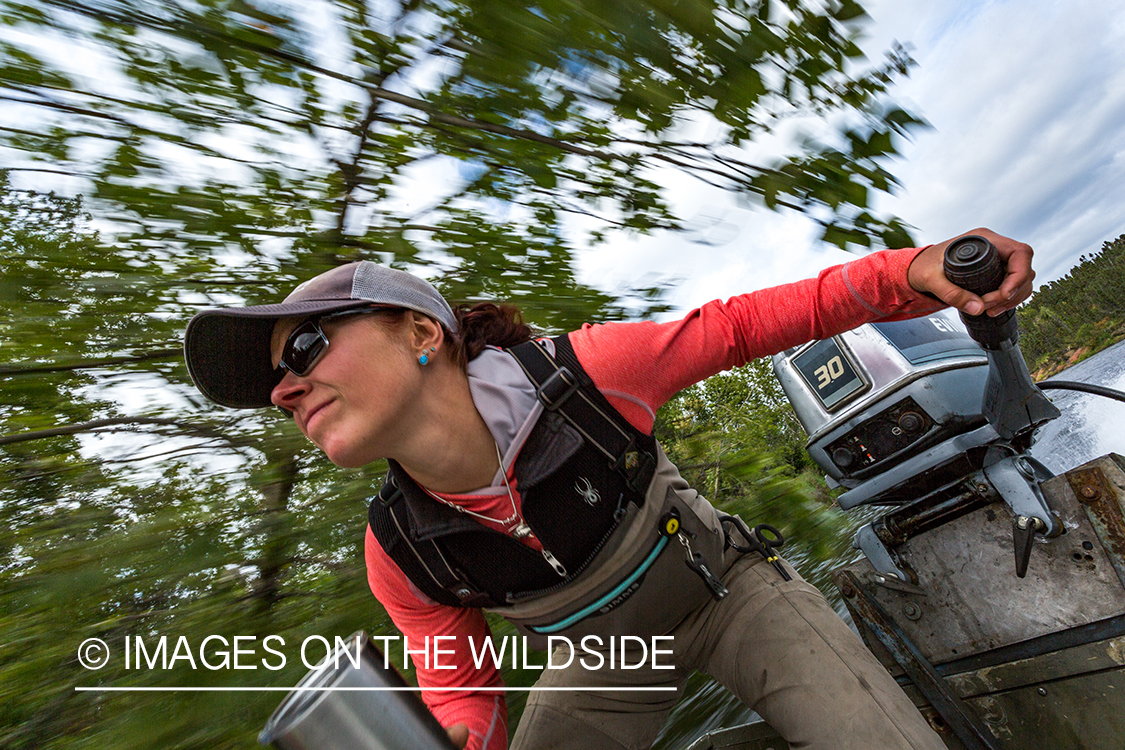 Flyfishing guide Camille Egdorf driving jetboat.