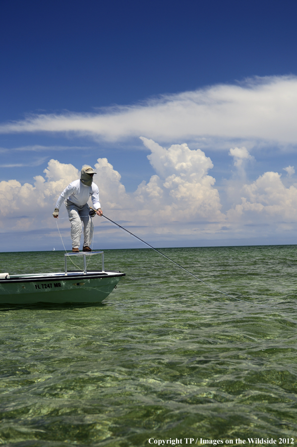 Flyfisherman on boat. 