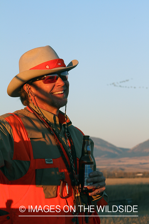 Upland game bird hunter in field.