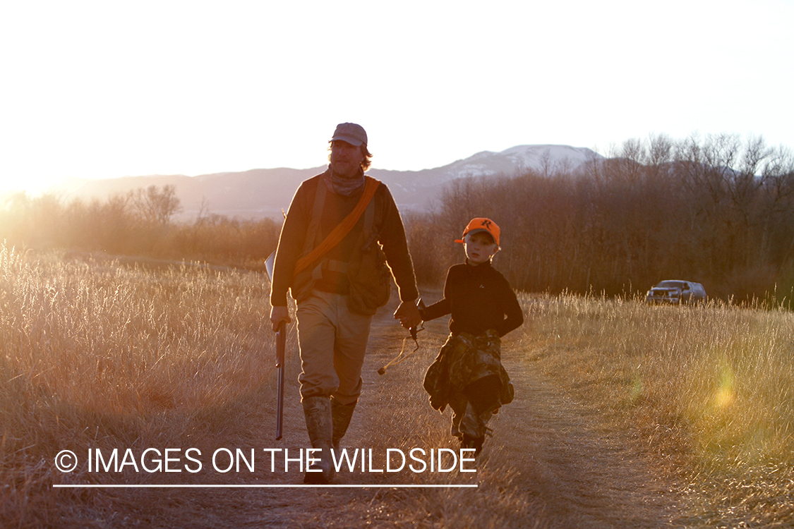 Father and son pheasant hunting.