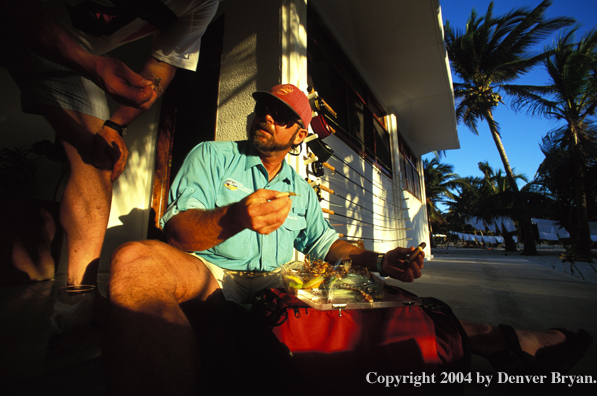 Saltwater flyfishermen checking gear.