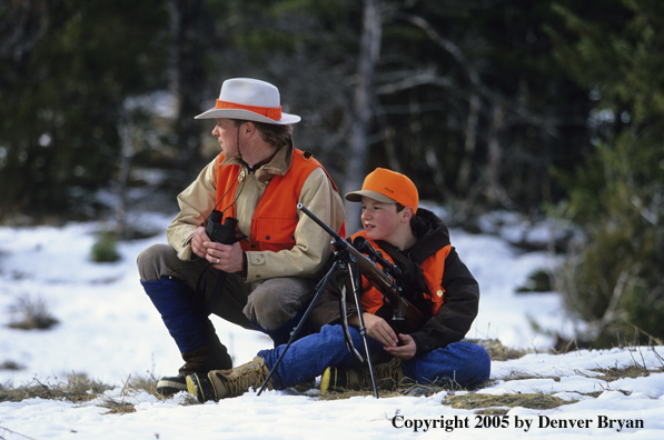 Father and son hunters big game hunting in winter.