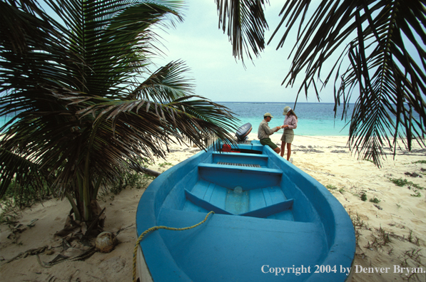 Saltwater flyfishing couple checking gear.