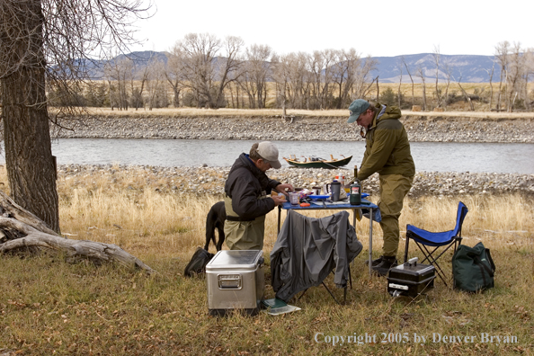 Flyfishermen eating shore lunch.