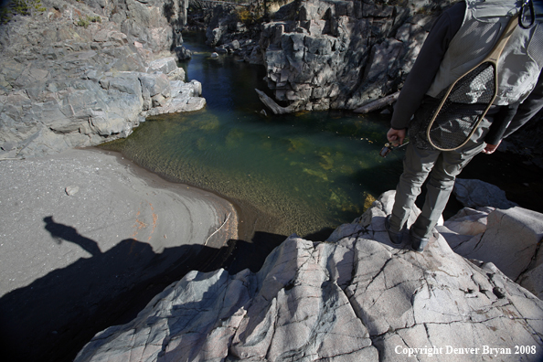 Flyfisherman standing atop Slot Canyon