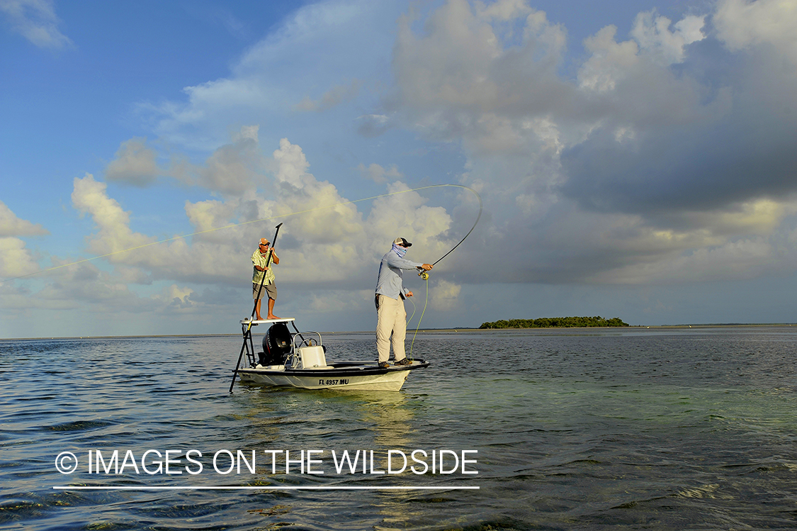 Saltwater flyfisherman casting on flats boat.