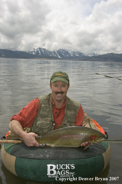 Flyfisherman with large cutthroat trout.