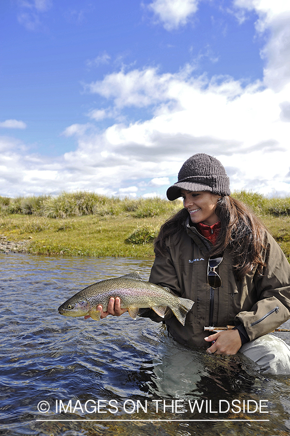 Flyfisherwoman with rainbow trout.