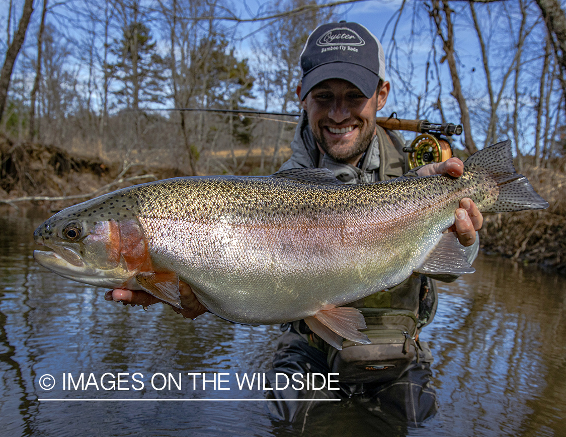 Flyfisherman with large rainbow trout.