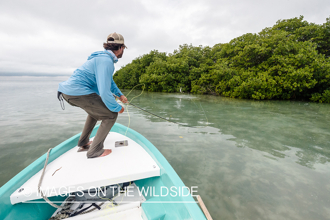 Flyfisherman fighting fish in Belize.