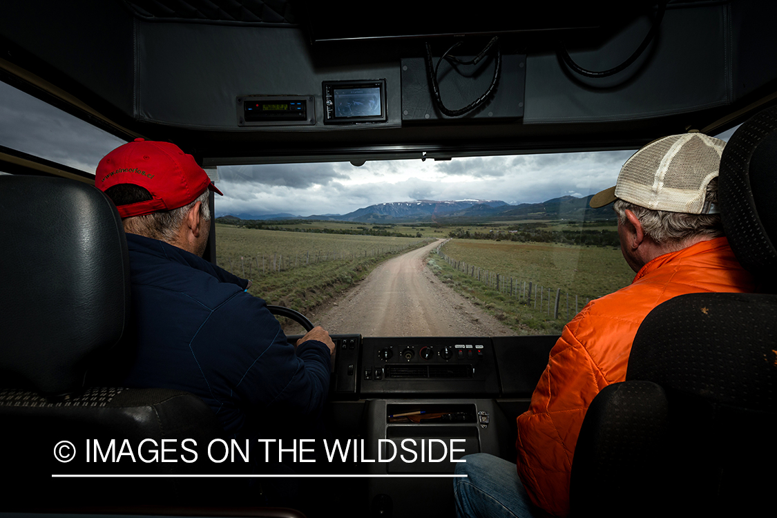 Flyfishermen driving down road.