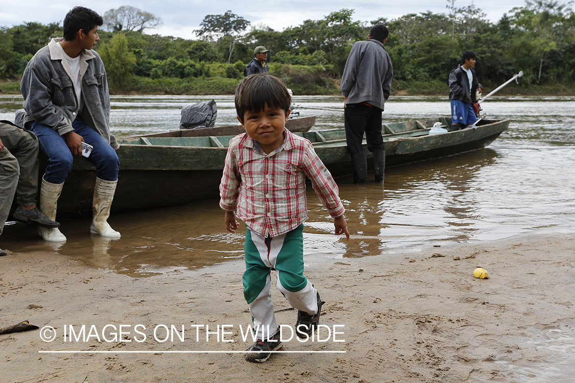 Native child by fishing boat.