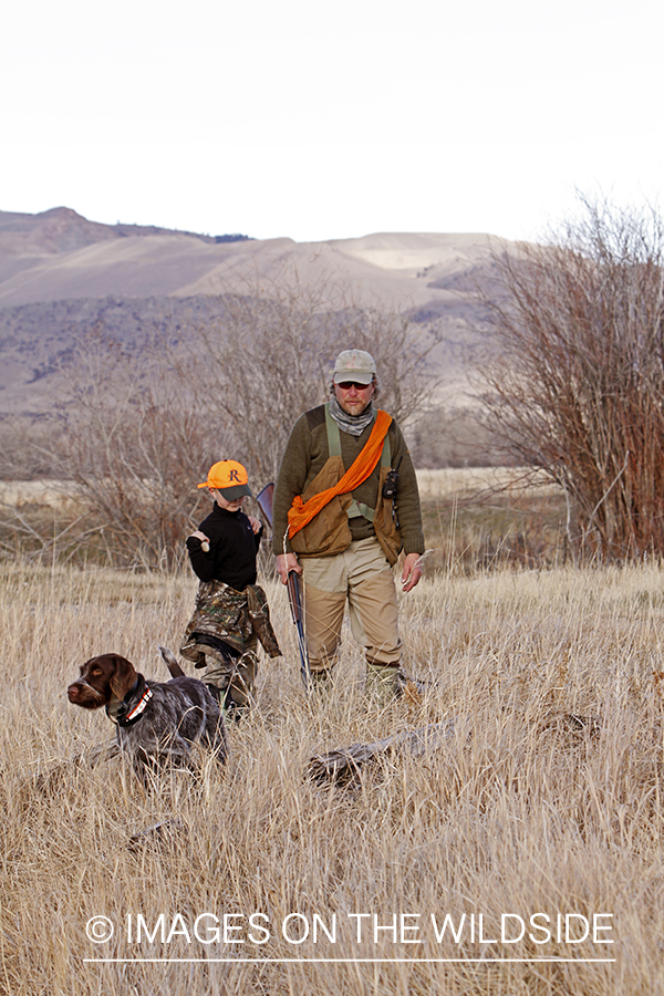 Father and son pheasant hunting.