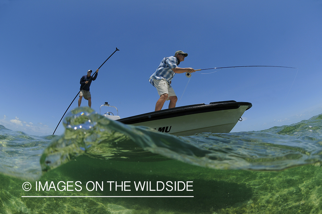 Saltwater flyfisherman casting on flats boat.