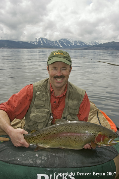 Flyfisherman with large cutthroat trout.