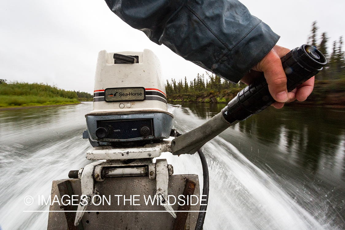 Flyfishing guide driving jetboat.