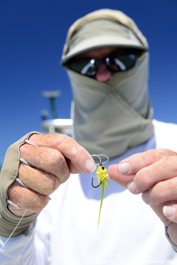 Flyfisherman with fly. 